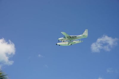 Low angle view of airplane flying against sky