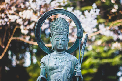 Close-up of statue against trees