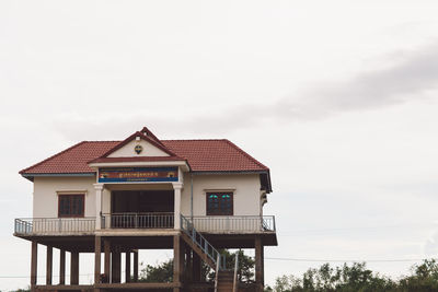 House by building against sky