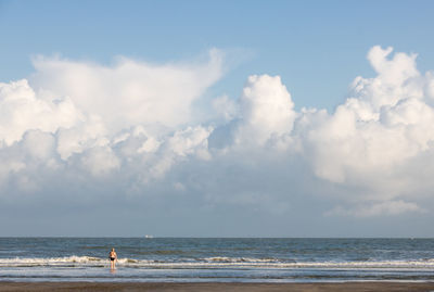 Single person walking on a huge beach in belgium along the north sea