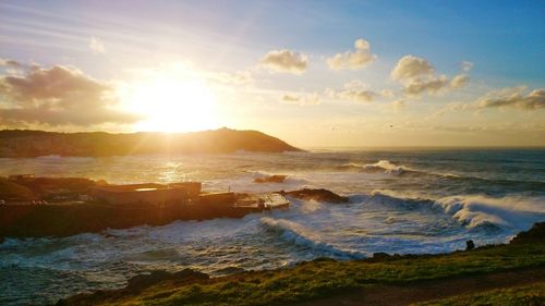 Scenic view of beach against sky during sunset