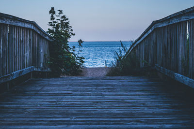 View of pier over sea against clear sky