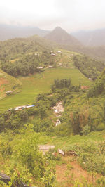 Scenic view of field and mountains against sky