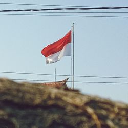 Low angle view of flag against the sky