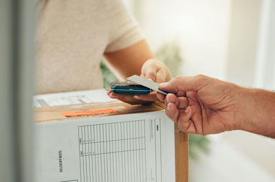 Midsection of woman using mobile phone