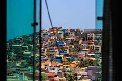 Buildings in city against clear sky