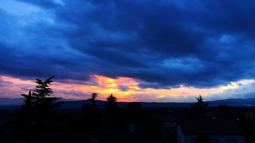 Dramatic sky over city at sunset