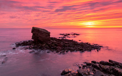 Scenic view of sea against romantic sky at sunset