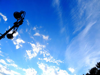 Low angle view of street light against blue sky