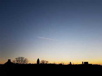 Silhouette landscape against sky during sunset