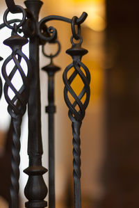 Close-up of metal fence against building