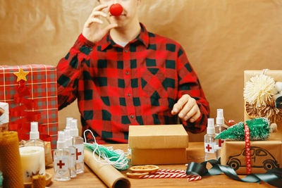 Midsection of man holding paper at home