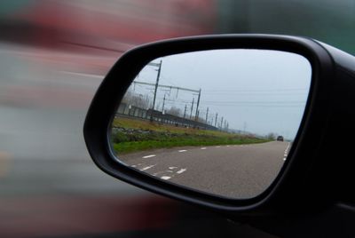 Reflection of car on side-view mirror