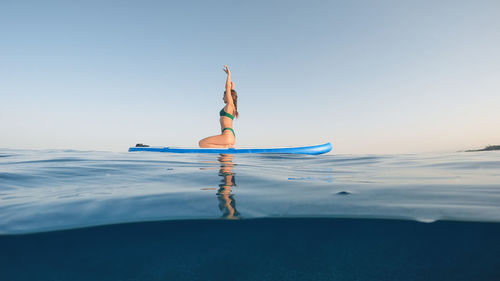 Girl on stand up paddle sup board in the sea