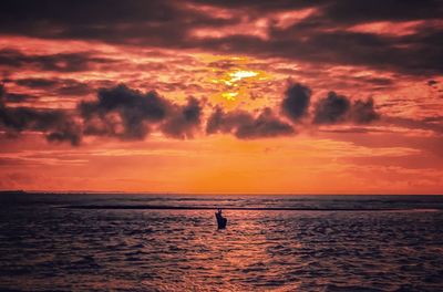 Scenic view of sea against orange sky