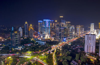 High angle view of illuminated buildings in city at night