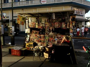 People sitting on chairs at market