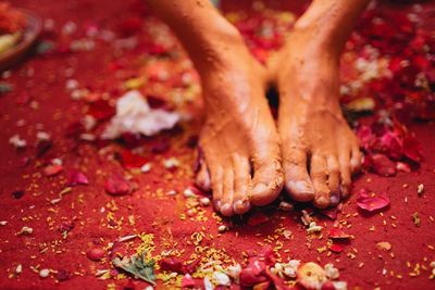 Close-up of bride with turmeric on feet during haldi