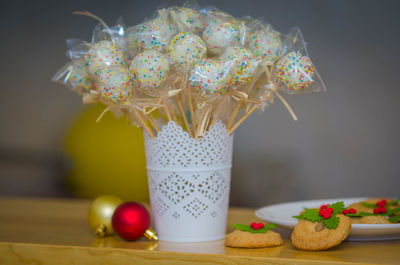 Close-up of sweet food with baubles on table