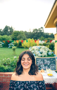 Smiling young woman at sidewalk cafe