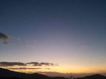 Scenic view of silhouette mountains against clear sky