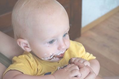 Close-up of cute baby boy eating cake