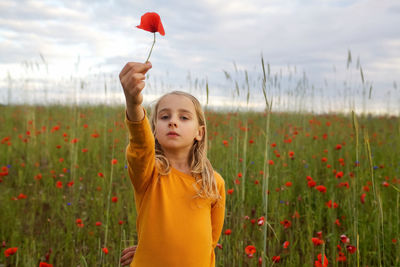 Cute girl standing on field