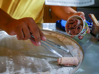 Midsection of woman working in kitchen