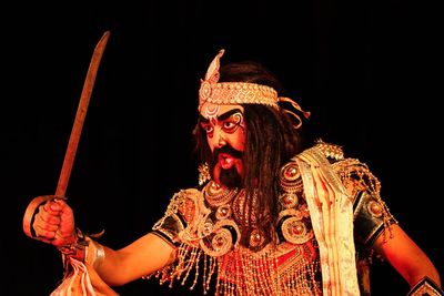 Low angle view of statue against black background