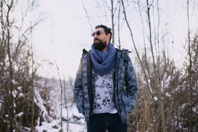 Young man standing in snow