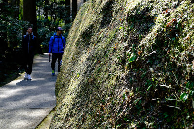 People on tree trunk