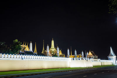 Illuminated building against sky at night