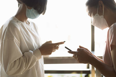 Midsection of woman using mobile phone