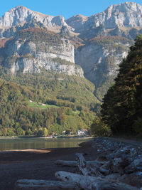 Scenic view of river by mountains