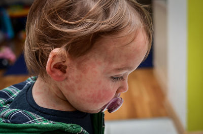 Close-up portrait of boy looking away at home