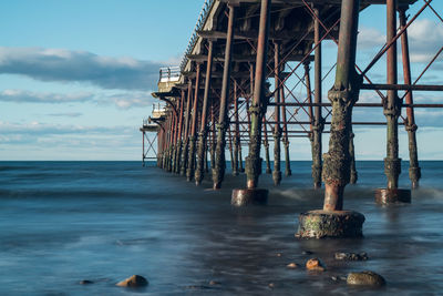 Pier over sea against sky