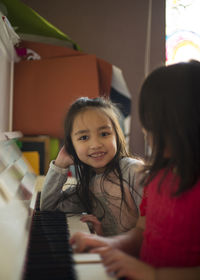 Cute girl smiling while sitting on floor