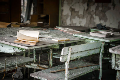 Empty chairs and table in abandoned room