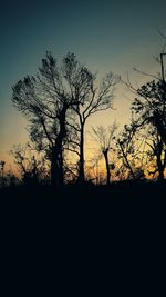 Silhouette trees against sky during sunset