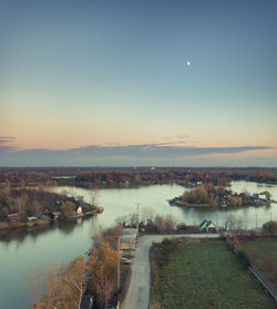 Scenic view of lake against sky at sunset