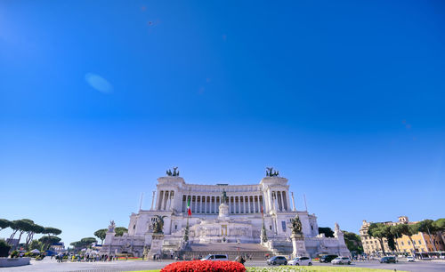 Low angle view of buildings against blue sky