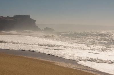Scenic view of beach against clear sky