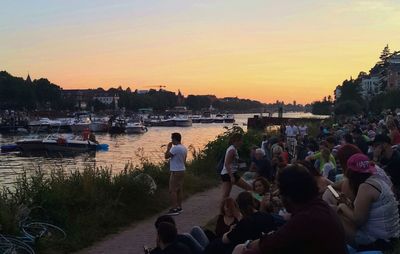 People in water at sunset