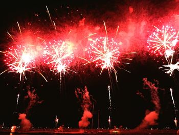 Low angle view of firework display at night