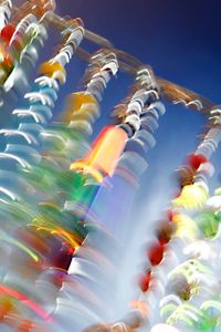 Low angle view of illuminated carousel against sky