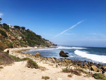 Scenic view of sea against blue sky