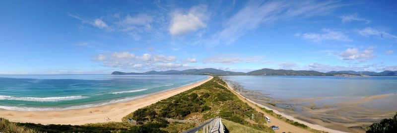 Panoramic view of beach against cloudy sky