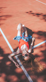 High angle view of woman lying on running track