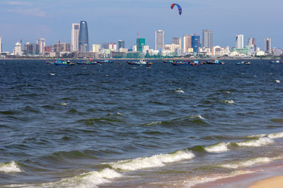 Scenic view of sea and buildings against sky