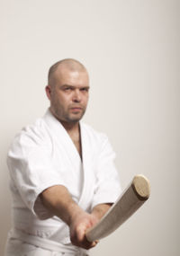 Portrait of man standing against white background